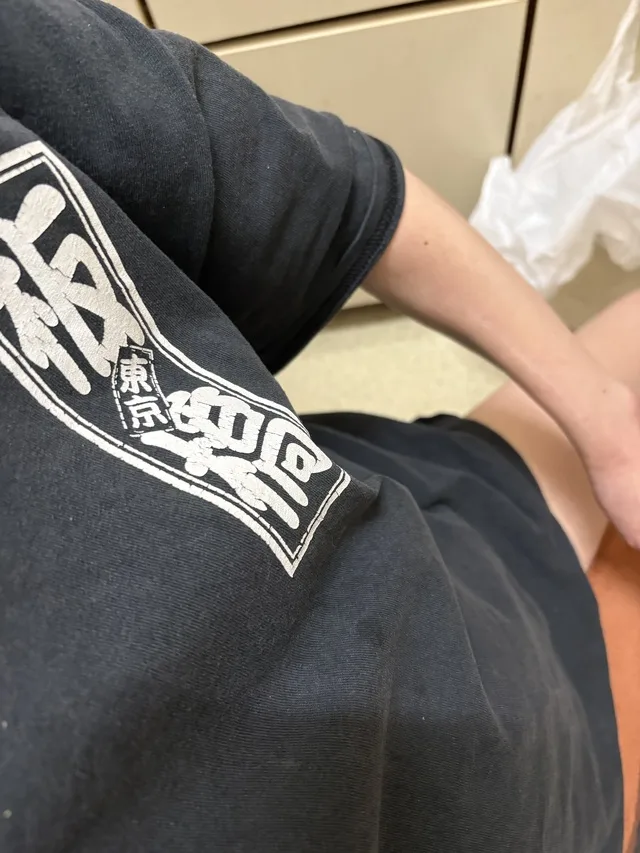 黒いTシャツを着た人の胴体と腕